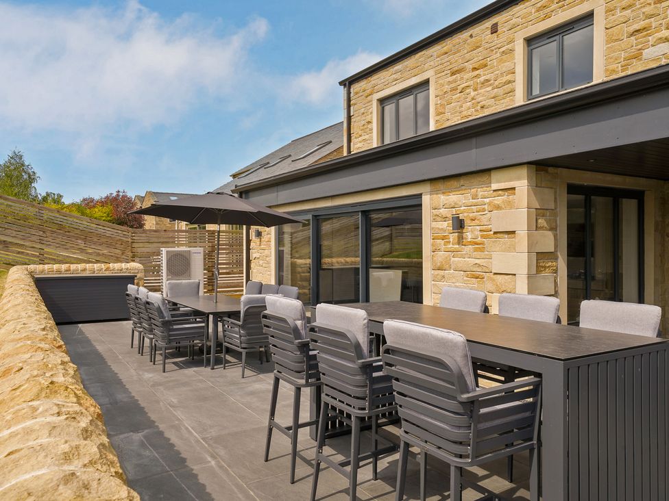 An outdoor dining area with a table and chairs at Northstone House in Blackburn