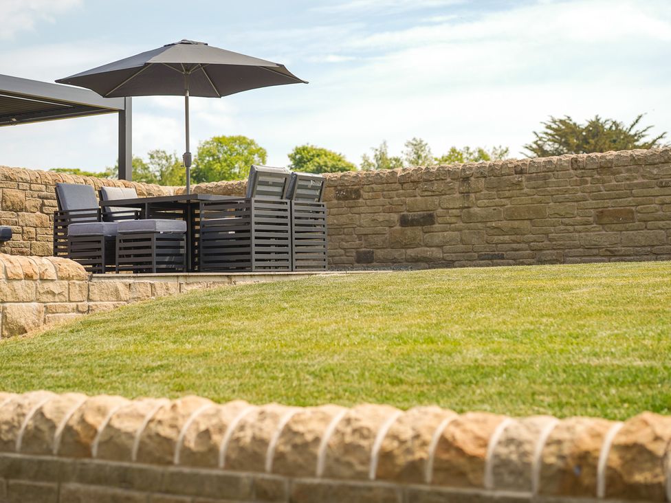 An outdoor seating area with a table and chairs at Northstone House Blackburn