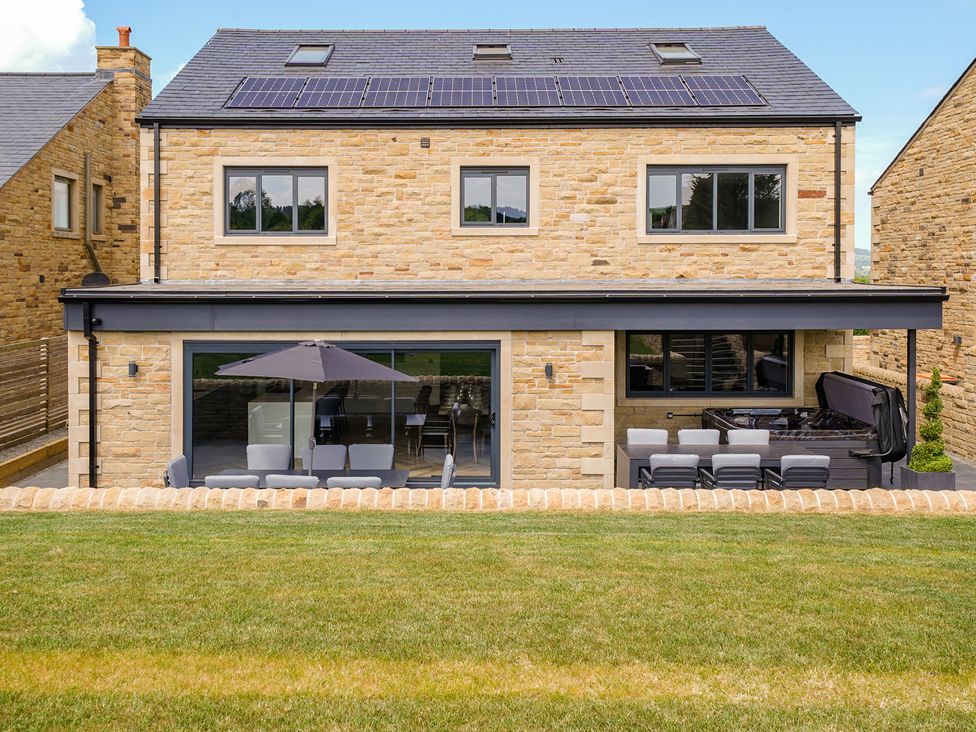 A house with solar panels and outdoor seating at Northstone House Blackburn