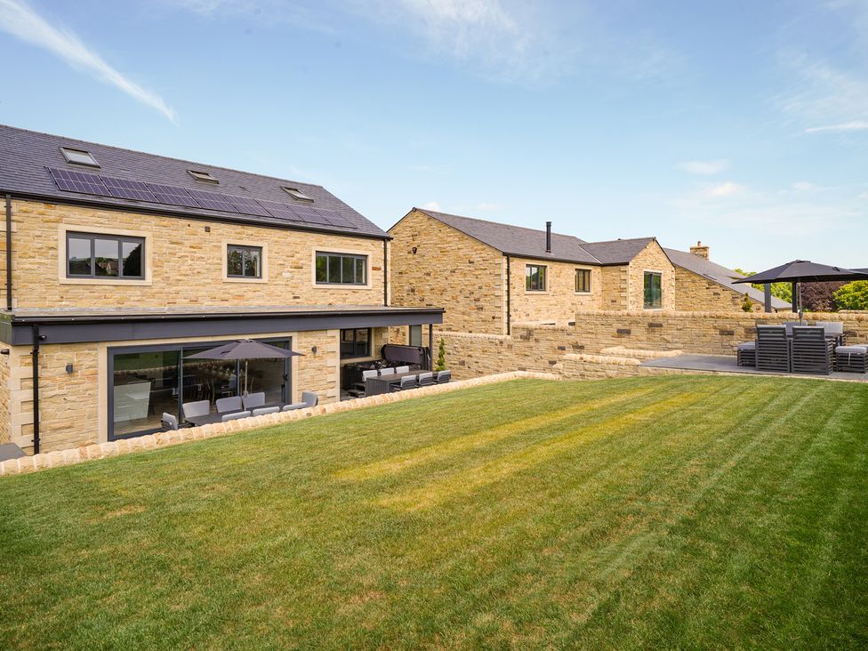 An outdoor area with houses and lawn at Northstone House in Blackburn