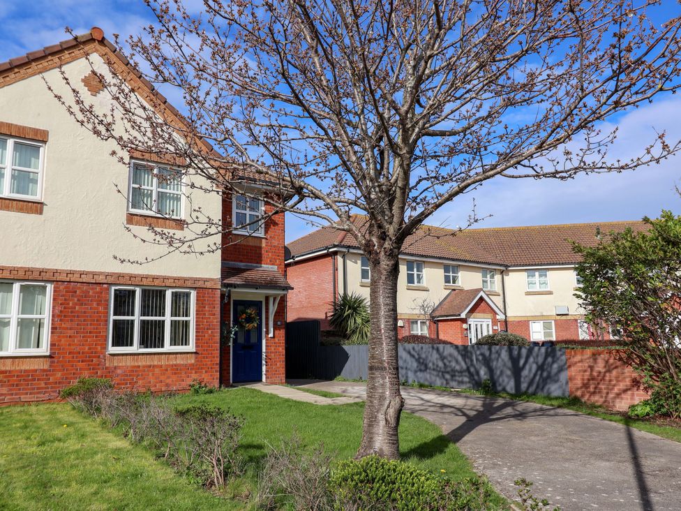 A house with a tree in the front yard at The Beach Escape in Prestatyn