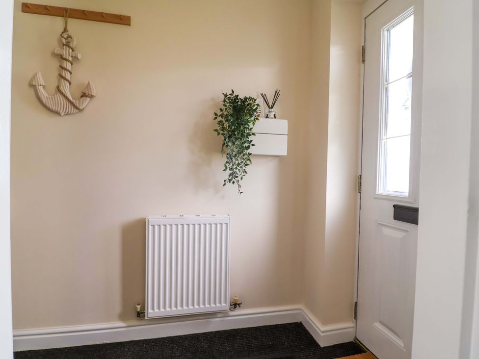 A hallway with an anchor decoration and a radiator at The Beach Escape in Prestatyn