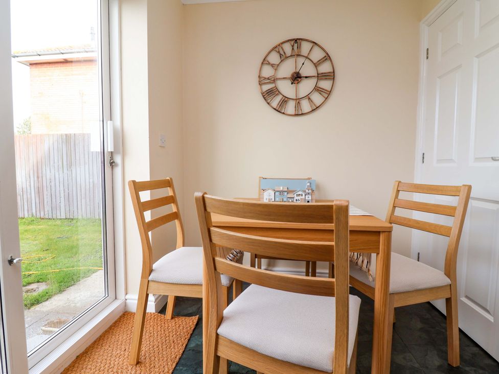 A dining room with a table and chairs at The Beach Escape in Prestatyn