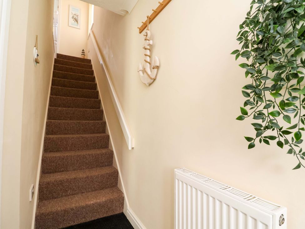 A staircase with an anchor decoration and a plant at The Beach Escape in Prestatyn