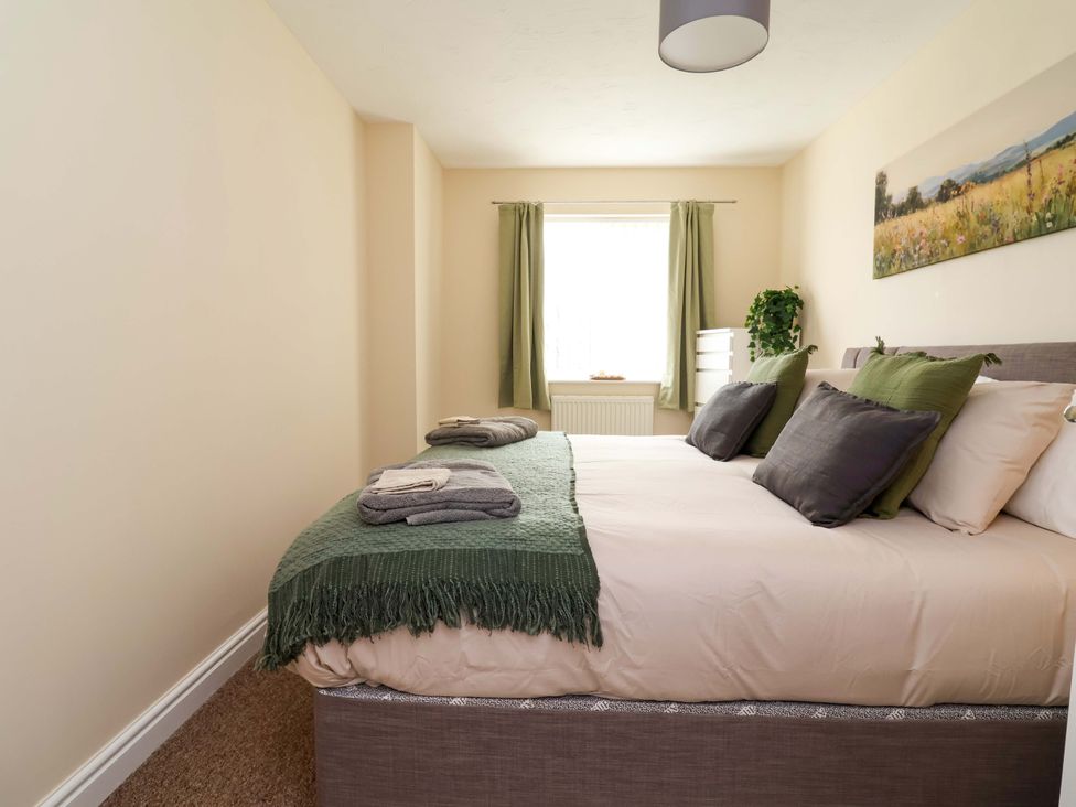 A bedroom with a bed and window at The Beach Escape in Prestatyn