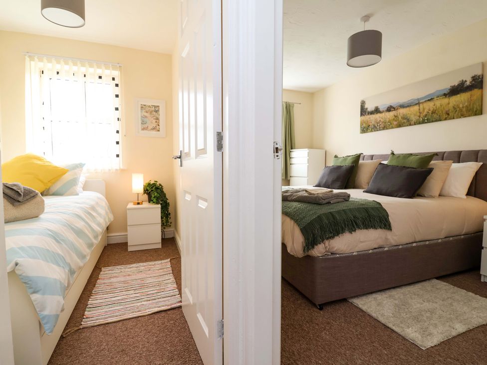 A bedroom with two beds and a window at The Beach Escape in Prestatyn