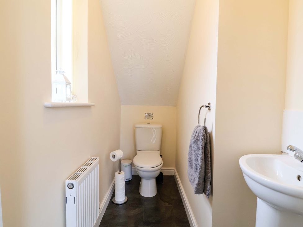 A bathroom with a toilet and sink at The Beach Escape in Prestatyn