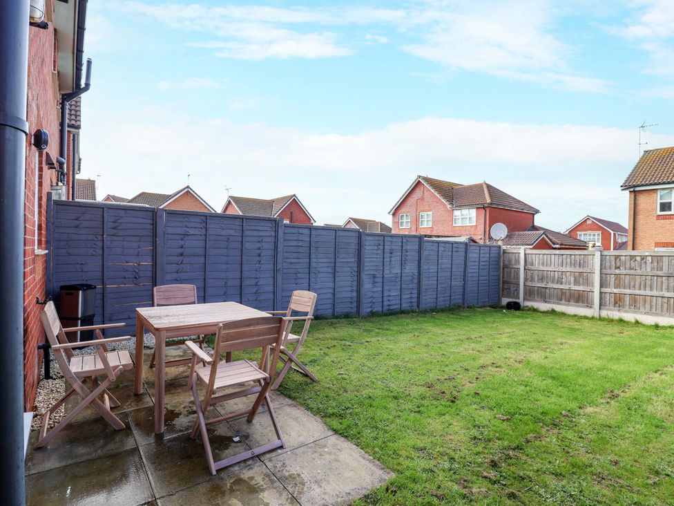 A garden with a table and chairs at The Beach Escape in Prestatyn