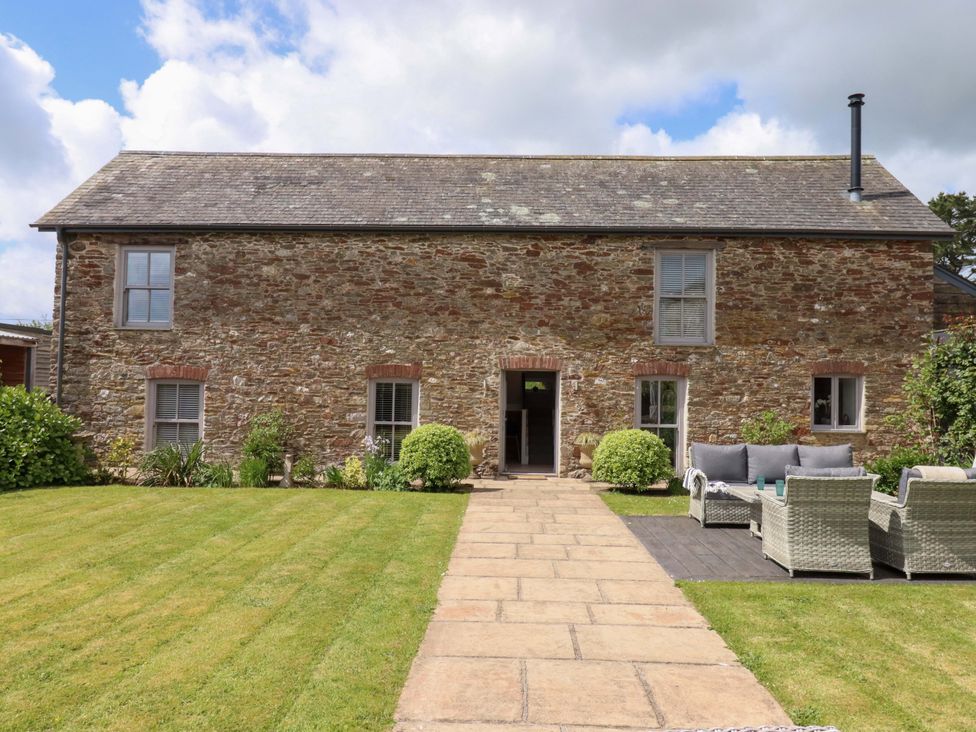 A house with a garden pathway and seating area at Duke's Barn in Blackawton near Dartmouth