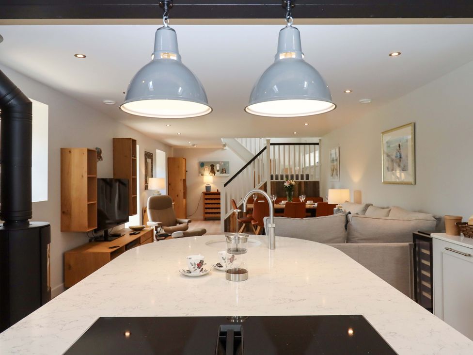 A kitchen with an island and a living area at Duke's Barn Blackawton near Dartmouth