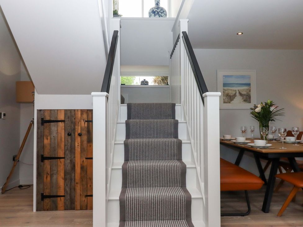 A staircase leading to a dining area at Duke's Barn in Blackawton near Dartmouth