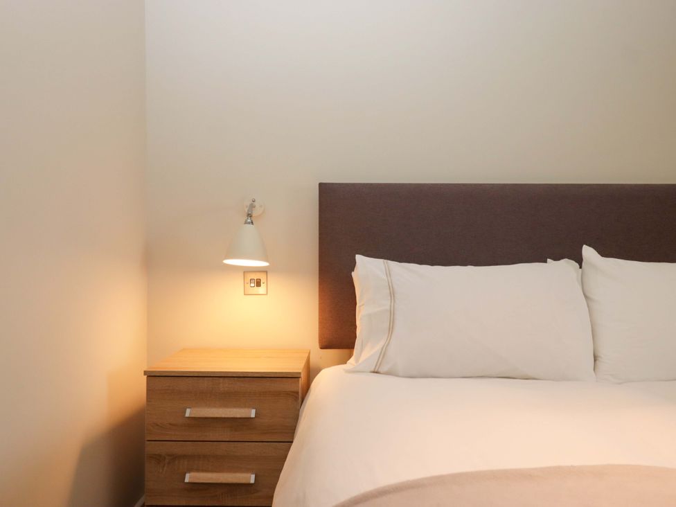 A bedroom with a bed and bedside table at Duke's Barn Blackawton near Dartmouth