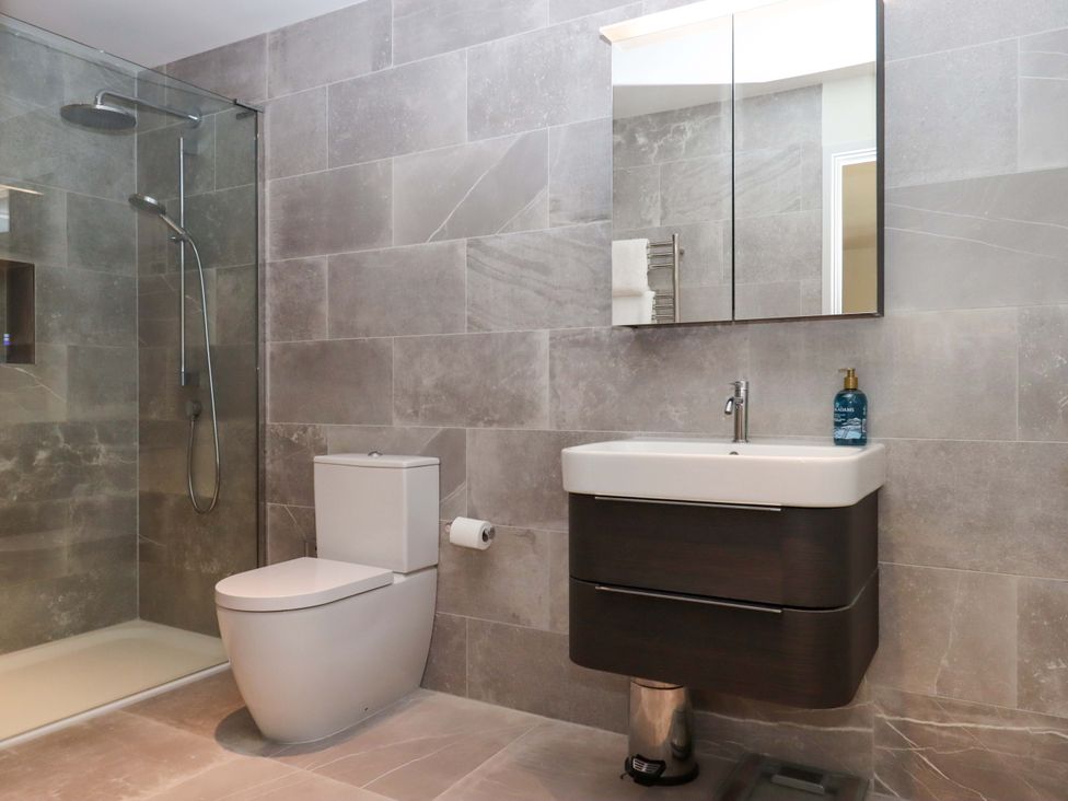 A bathroom featuring a shower, toilet, and sink at Duke's Barn in Blackawton near Dartmouth