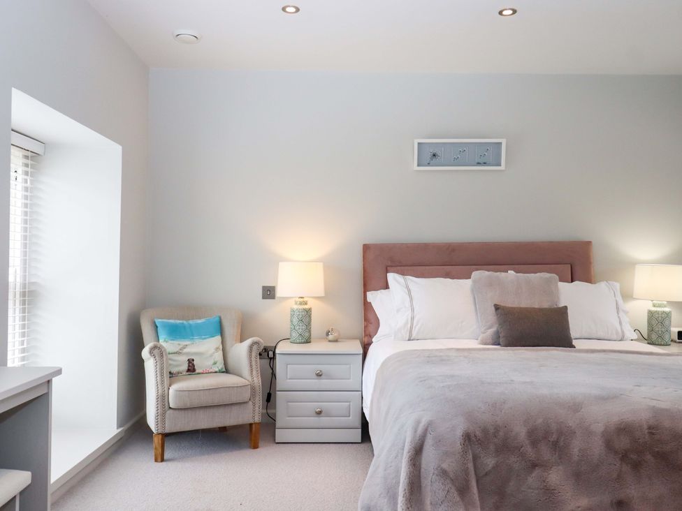A bedroom with a bed and nightstand at Duke's Barn in Blackawton near Dartmouth