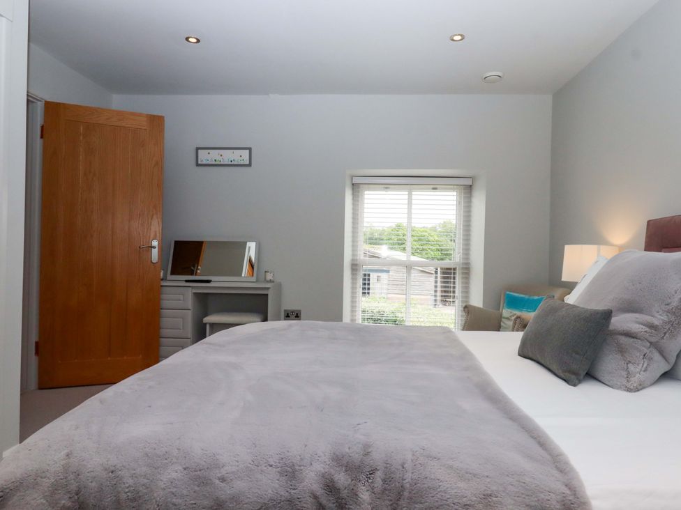 A bedroom with a bed and desk at Duke's Barn Blackawton near Dartmouth