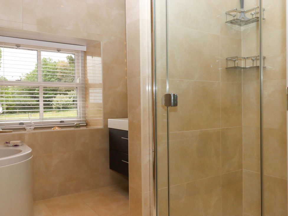 A bathroom with a bathtub, shower, and sink at Duke's Barn in Blackawton near Dartmouth
