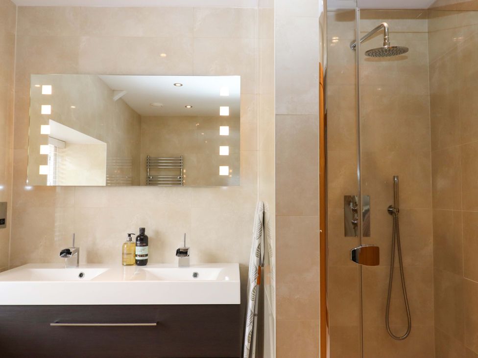 A bathroom with a double basin and shower at Duke's Barn Blackawton near Dartmouth