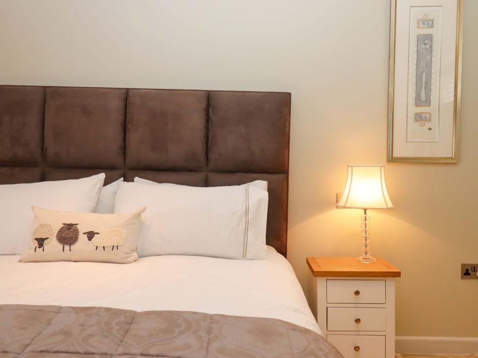 A bedroom with a bed and bedside table at Duke's Barn Blackawton near Dartmouth