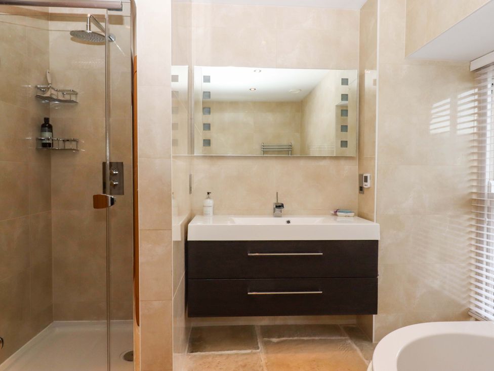 A bathroom with a shower and sink at Duke's Barn in Blackawton near Dartmouth
