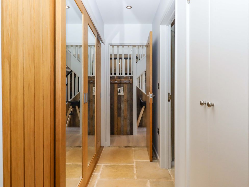 A hallway with mirrors and a staircase at Duke's Barn Blackawton near Dartmouth