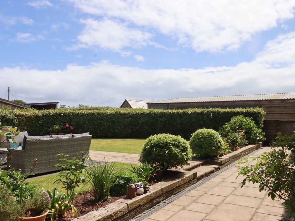 A garden with a sofa and hedges at Duke's Barn Blackawton near Dartmouth