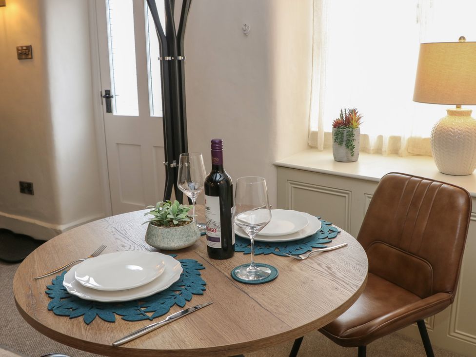 A dining room table set with wine and glassware at The Toll Bar in Hope Valley