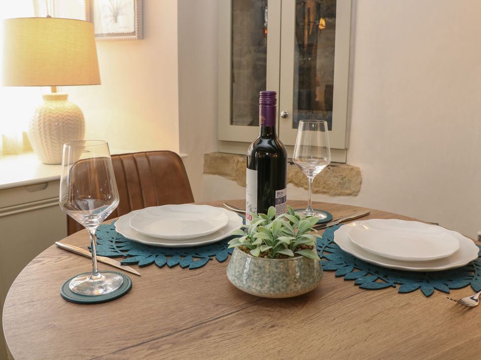 A dining table with wine and tableware at The Toll Bar in Hope Valley