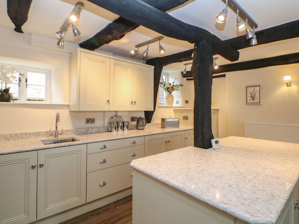 A kitchen with cabinets and a countertop at The Toll Bar in Hope Valley
