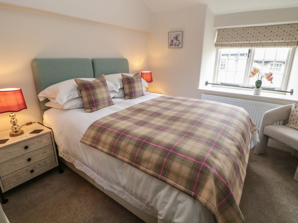 A bedroom with a bed and a bedside table at The Toll Bar in Hope Valley