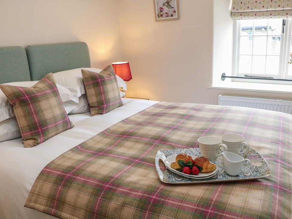 A bedroom with a bed and breakfast tray at The Toll Bar in Hope Valley