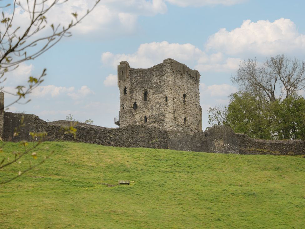 A castle surrounded by walls on a grassy area at The Toll Bar in Hope Valley