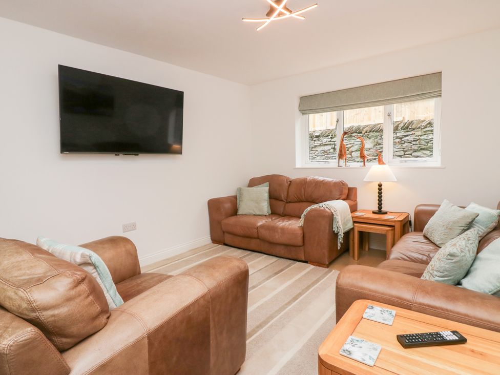 A living room with a sofa and a television at Catbells in Windermere
