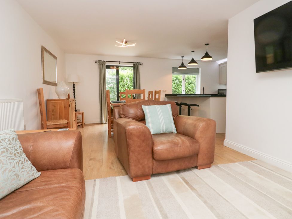 A living room with a sofa and armchair at Catbells in Windermere