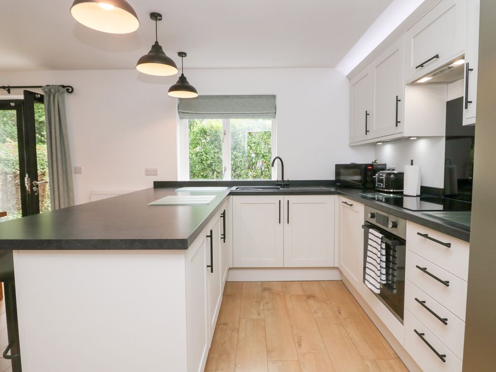 A kitchen with cabinets and a counter at Catbells in Windermere