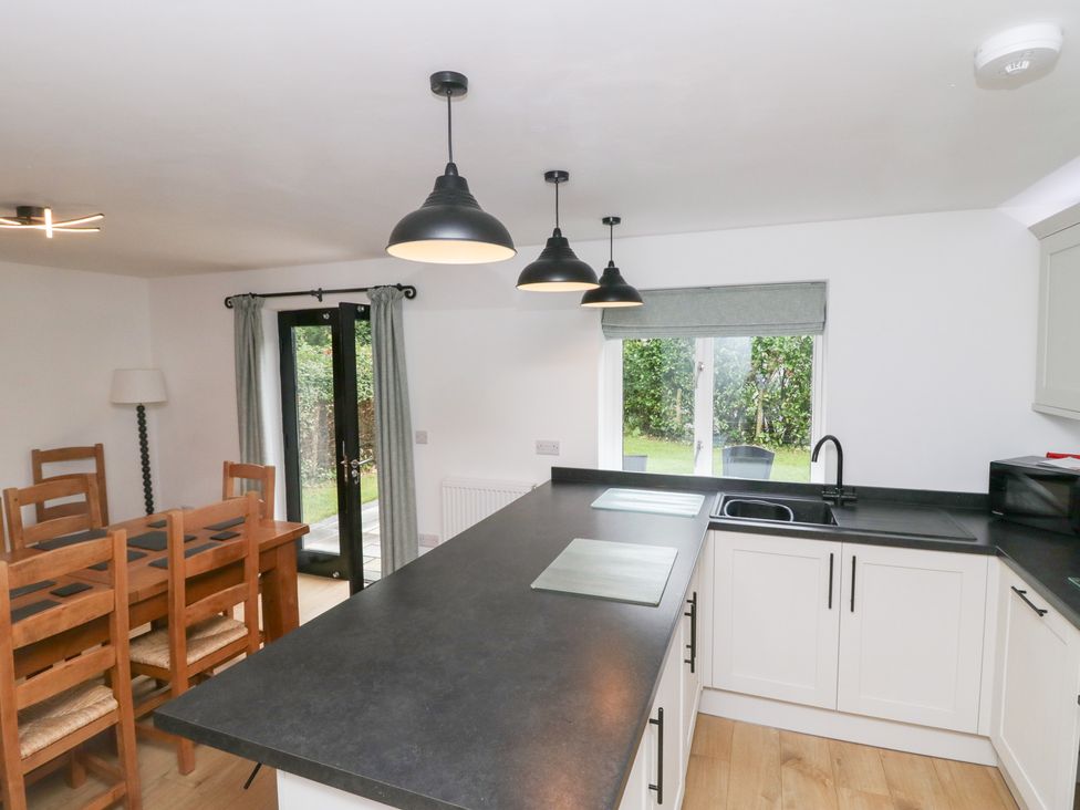 A kitchen with dining area and view of garden at Catbells in Windermere