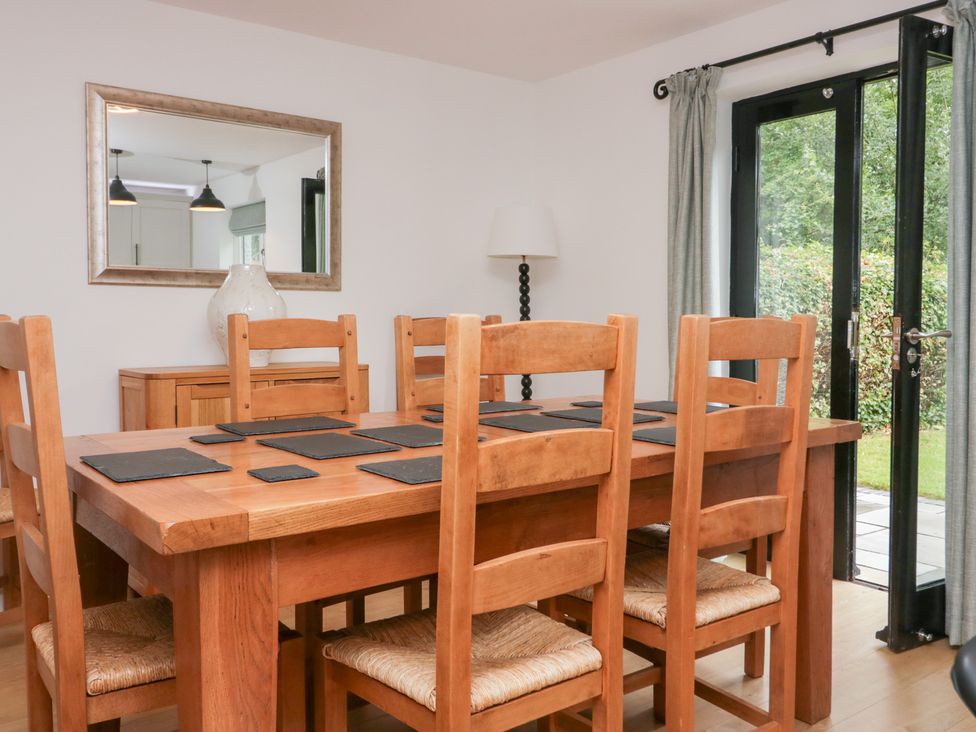 A dining room with a wooden table and chairs at Catbells in Windermere