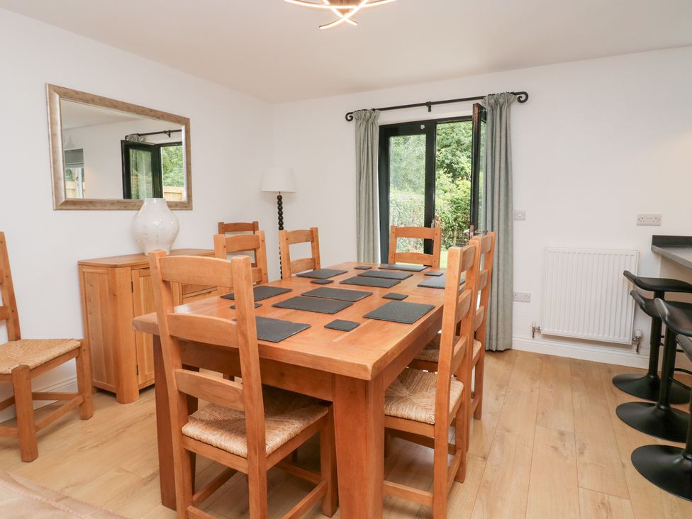 A dining room with a table and chairs at Catbells in Windermere