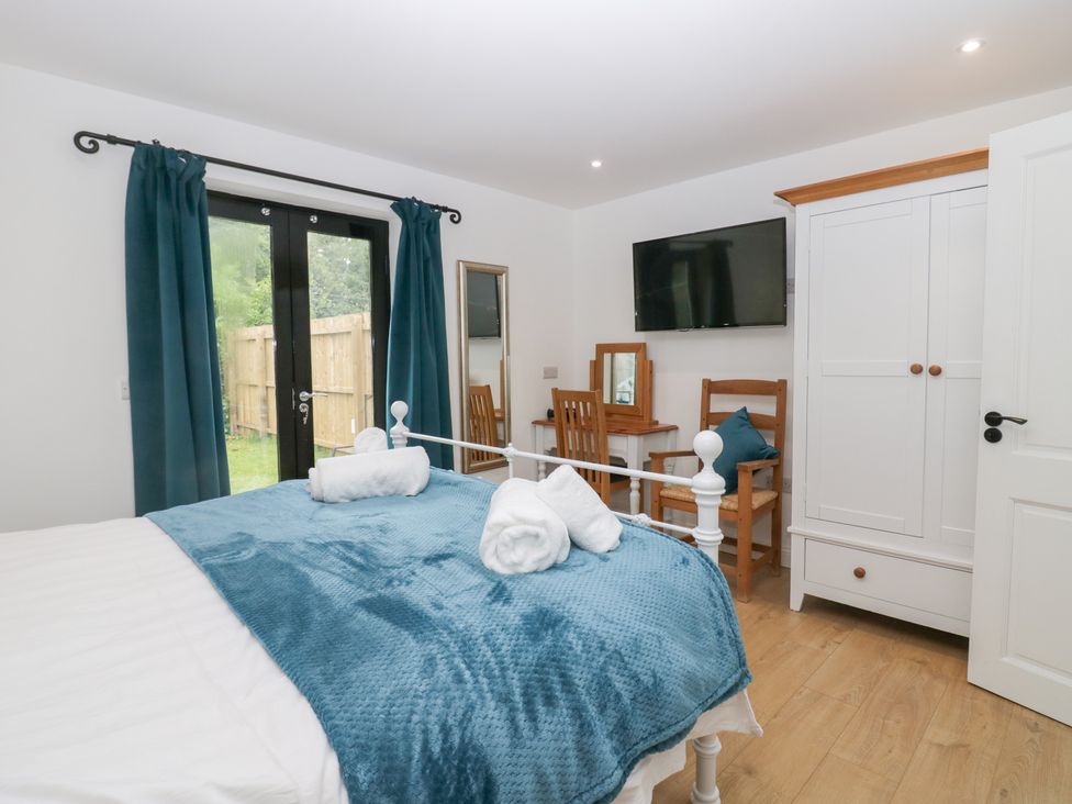 A bedroom with a double bed and television at Catbells in Windermere