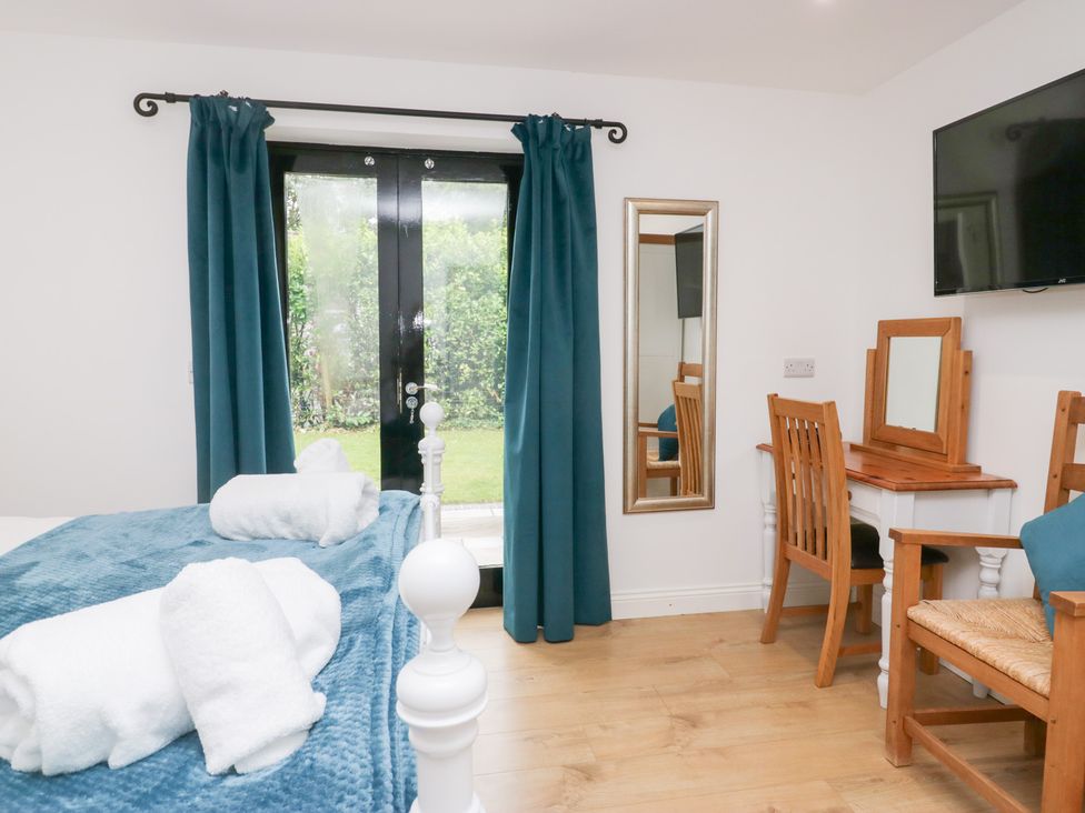 A bedroom with a bed and a table at Catbells in Windermere