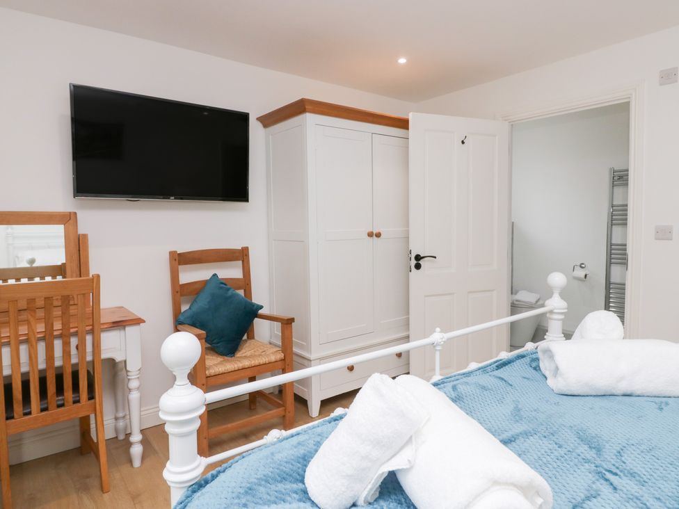 A bedroom with a bed and a television at Catbells in Windermere