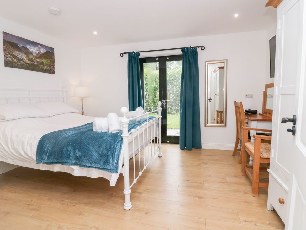 A bedroom with a bed and desk at Catbells in Windermere