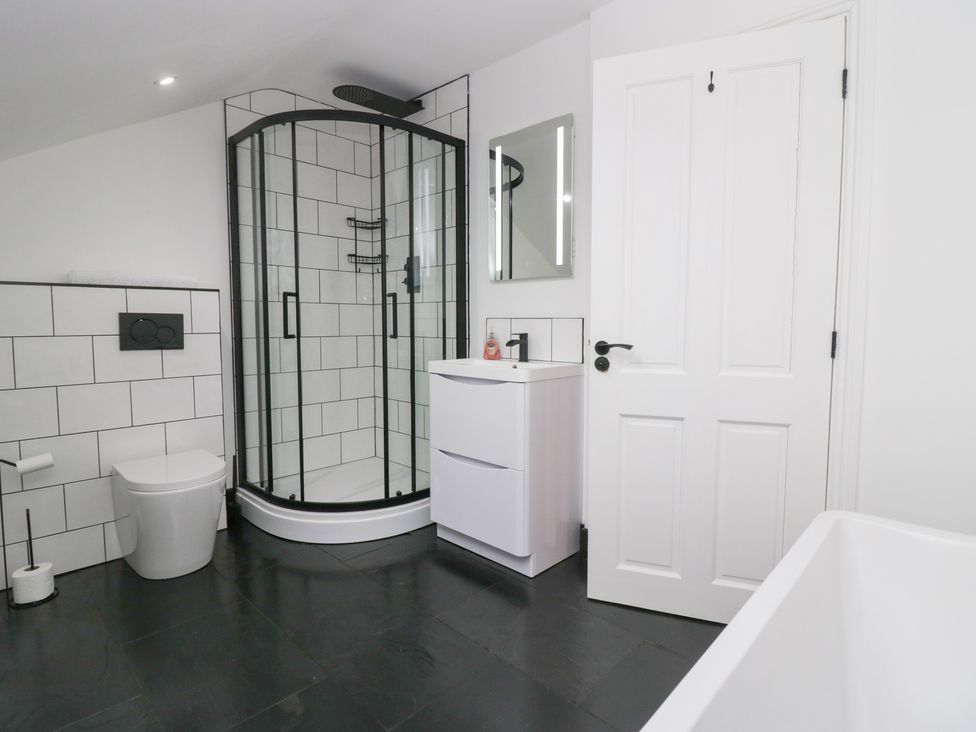A bathroom with a shower, toilet, and sink at Catbells in Windermere