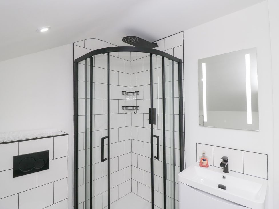 A bathroom with a shower and sink at Catbells in Windermere