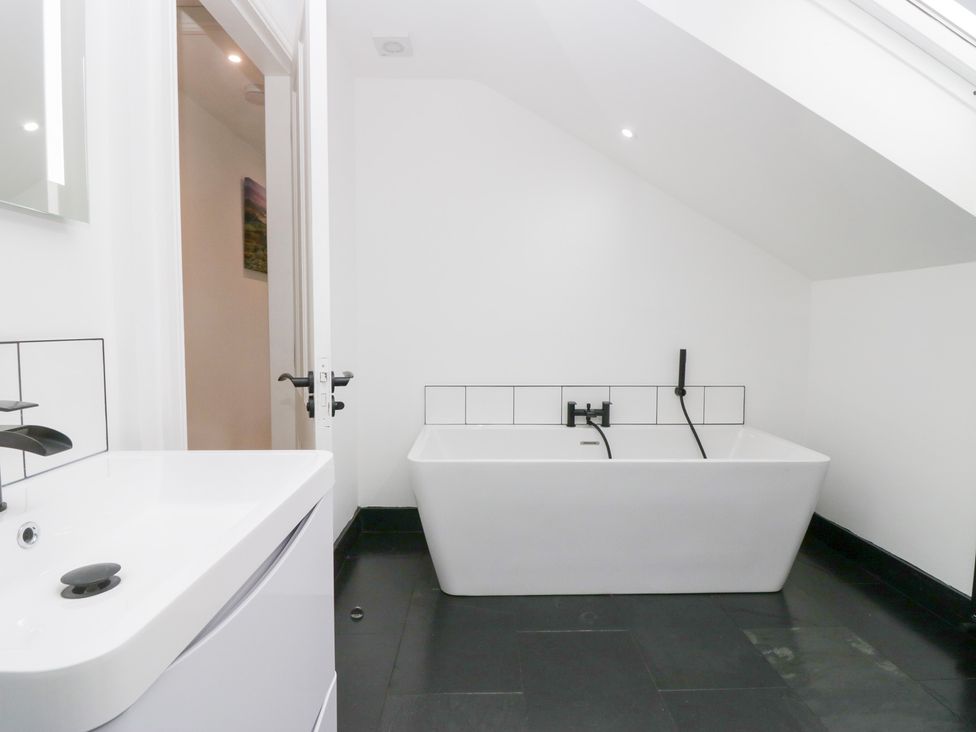 A bathroom with a bathtub and sink at Catbells in Windermere