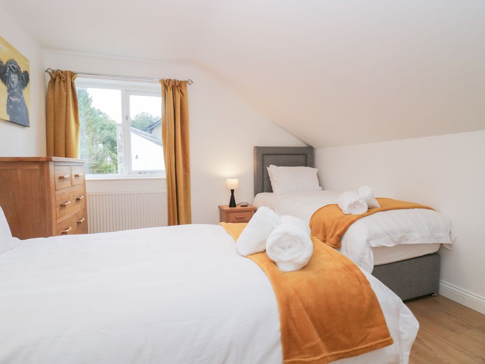 A bedroom with two beds and a drawer at Catbells in Windermere