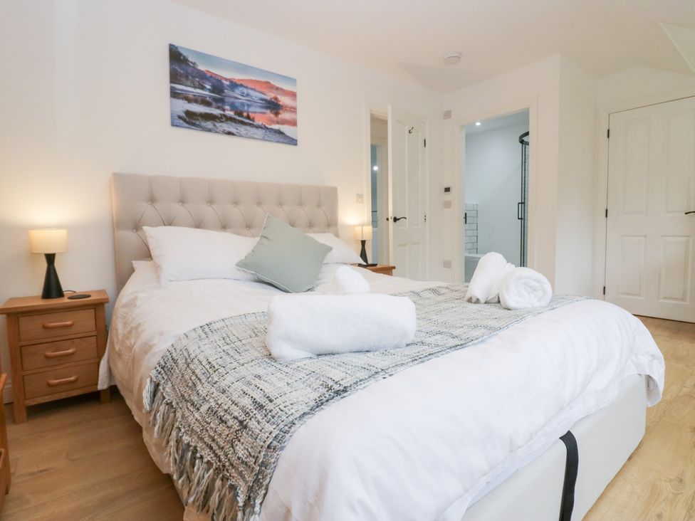 A bedroom with a bed and nightstand at Catbells in Windermere