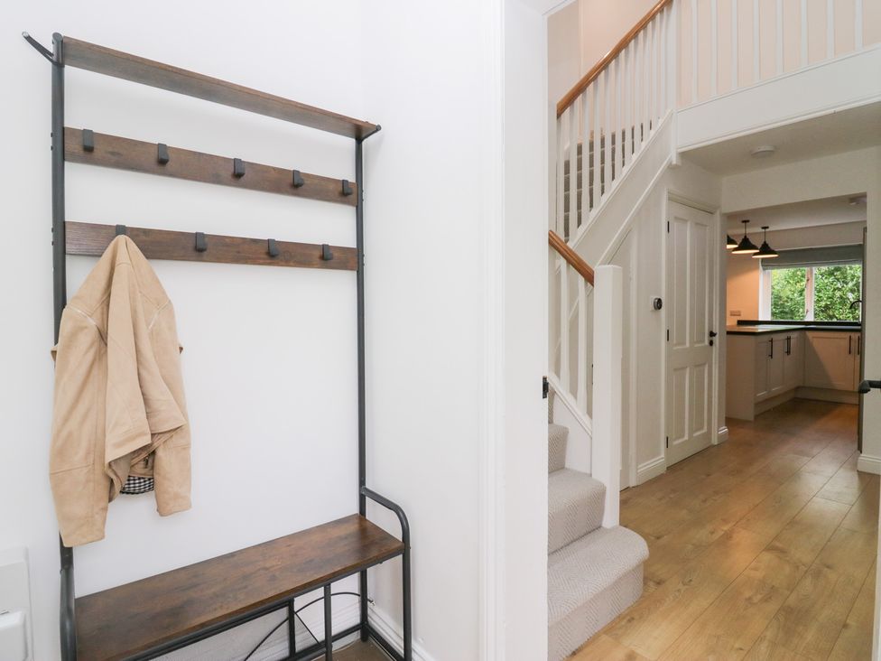 A hallway with a coat rack and bench at Catbells in Windermere