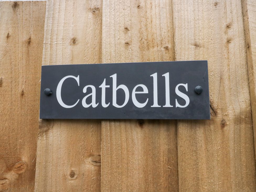 A sign with the name Catbells on a wooden fence at Catbells in Windermere