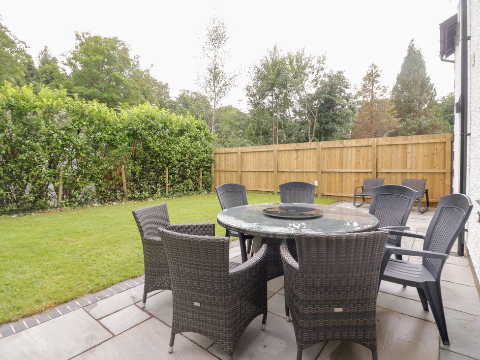 A garden with a table and chairs at Catbells in Windermere