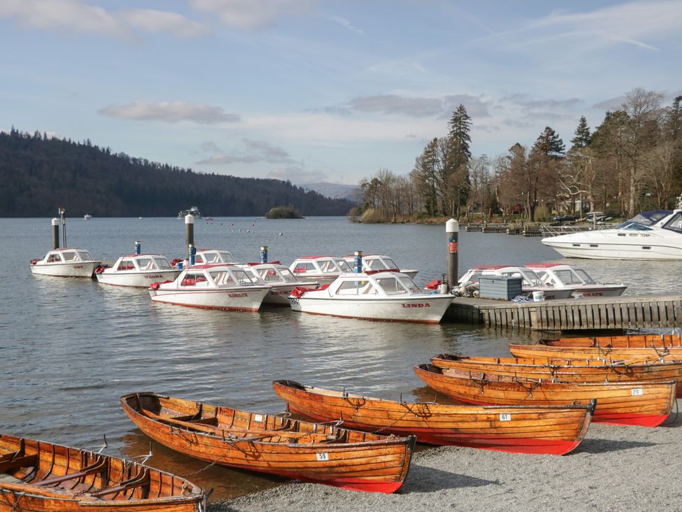 A row of boats at a dock by the water at Catbells in Windermere